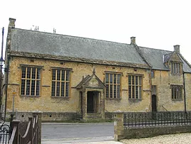 16th century building showing gabled porch and 4 large windows.  Original grammar school now the church hall