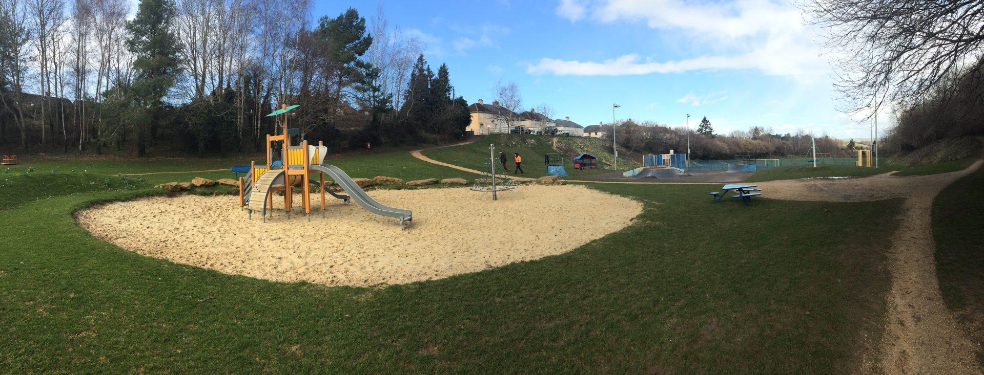 Children's slide in green space play area
